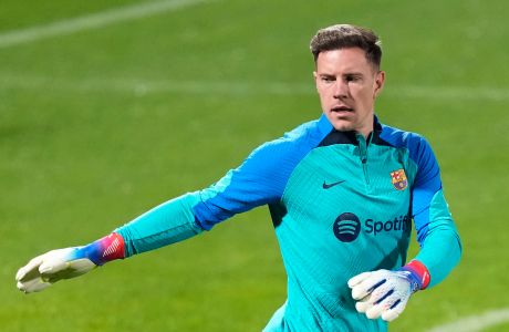 Barcelona's goalkeeper Marc-Andre ter Stegen, arms up during a training session, at Al Nassr stadium, in Riyadh, Saudi Arabia, Saturday, Jan. 14, 2023. Barcelona will play the Spanish Super Cup final soccer match against Real Madrid on Sunday Jan. 15,  at King Fahd stadium in Riyadh. (AP Photo/Hussein Malla)