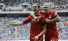 Liverpool's Andy Carroll, left, celebrates his goal against Everton with teammate Martin Skrtel during their English FA Cup semifinal soccer match at Wembley Stadium in London, Saturday, April 14, 2012. (AP Photo/Tom Hevezi)