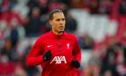 Liverpool's Virgil van Dijk runs during the warm up prior to the start of the English FA Cup fourth round soccer match between Liverpool and Norwich, at Anfield stadium in Liverpool, England, Sunday, Jan. 28, 2024. (AP Photo/Jon Super)