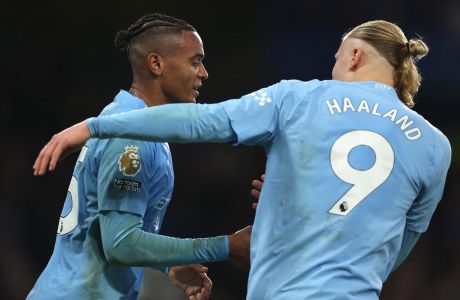 Manchester City's Manuel Akanji, left, celebrates with Erling Haaland after scoring his side's second goal during the English Premier League soccer match between Chelsea and Manchester City at Stamford Bridge stadium in London, Sunday, Nov. 12, 2023. (AP Photo/Ian Walton)