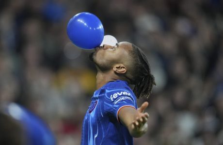 Chelsea's Christopher Nkunku celebrates after scoring his side's third goal during the Europa Conference League opening phase soccer match between Chelsea and Gent at Stamford Bridge in London, Thursday, Oct. 3, 2024. (AP Photo/Kin Cheung)