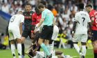 Real Madrid's Eder Militao screams after an injury during the Spanish La Liga soccer match between Real Madrid and Osasuna at the Santiago Bernabeu stadium in Madrid, Spain, Saturday, Nov. 9, 2024. (AP Photo/Jose Breton)