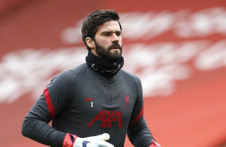 FILE - In this Sunday, March 7, 2021 file photo, Liverpool's goalkeeper Alisson warms up prior to their English Premier League soccer match against Fulham at Anfield stadium in Liverpool, England. Liverpool goalkeeper Alisson Becker signed a long-term contract extension on Wednesday, Aug. 4 the club said. The 28-year-old Brazil keeper's deal follows midfielder Fabinho and right back Trent Alexander-Arnold also extending at Liverpool. (Phil Noble/Pool via AP, file)