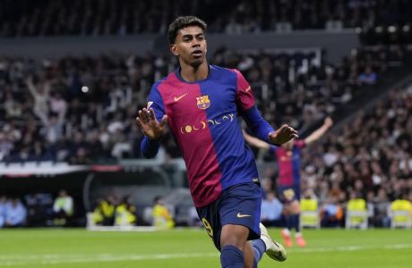 Barcelona's Lamine Yamal celebrates after scoring his side's third goal during a Spanish La Liga soccer match between Real Madrid and Barcelona at the Santiago Bernabeu stadium in Madrid, Spain, Saturday, Oct. 26, 2024. (AP Photo/Manu Fernandez)