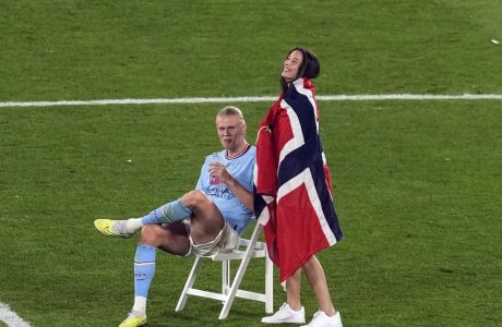 Manchester City's Erling Haaland smiles as he sits on the pitch after winning the Champions League final soccer match between Manchester City and Inter Milan at the Ataturk Olympic Stadium in Istanbul, Turkey, Sunday, June 11, 2023. (AP Photo/Thanassis Stavrakis)