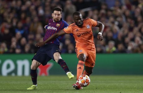 Barcelona forward Lionel Messi, left, fights for the ball with Lyon midfielder Tanguy Ndombele during the Champions League round of 16, 2nd leg, soccer match between FC Barcelona and Olympique Lyon at the Camp Nou stadium in Barcelona, Spain, Wednesday, March 13, 2019. (AP Photo/Manu Fernandez)