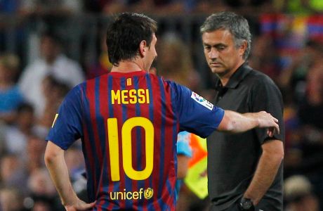 FC Barcelona's Lionel Messi from Argentina, right, reacts with Real Madrid's coach Jose Mourinho from Portugal, left,  during a second leg Spanish Supercup soccer match at the Camp Nou stadium in Barcelona, Spain, Wednesday, Aug. 17, 2011. (AP Photo/Andres Kudacki)