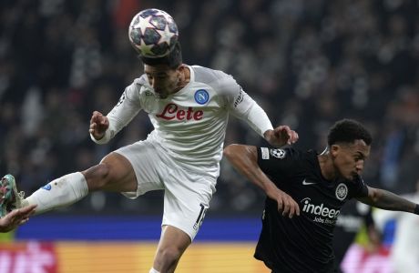 Napoli's Giovanni Simeone, left, jumps for the ball with Frankfurt's Tuta during the Champions League round of 16 second leg soccer match between Eintracht Frankfurt and Napoli, at the Deutsche Bank Arena in Frankfurt, Germany, Tuesday, Feb. 21, 2023. (AP Photo/Michael Probst)