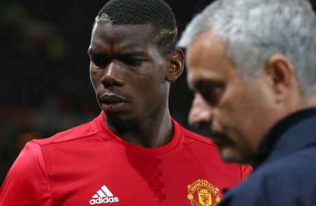 Manchester Uniteds manager José Mourinho, right, with Manchester Uniteds Paul Pogba just prior to the start of Europa League group A soccer match between Manchester United and Zorya Luhansk at Old Trafford, Manchester, England, Thursday, Sept. 29, 2016. (AP Photo/Dave Thompson)