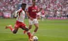 Bayern's Kingsley Coman, left, is challenged by Cologne's Max Finkgraefe during the German Bundesliga soccer match between Bayern Munich and Cologne at the Allianz Arena in Munich, Germany, Saturday, April 13, 2024. (AP Photo/Matthias Schrader)