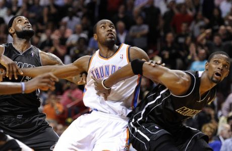 Miami Heat's LeBron James (L) and Chris Bosh (R) wait for a rebound with Oklahoma City Thunder's Serge Ibaka  during the second half of their NBA basketball game in Miami, Florida April 4, 2012.  REUTERS/Rhona Wise (UNITED STATES - Tags: SPORT BASKETBALL)