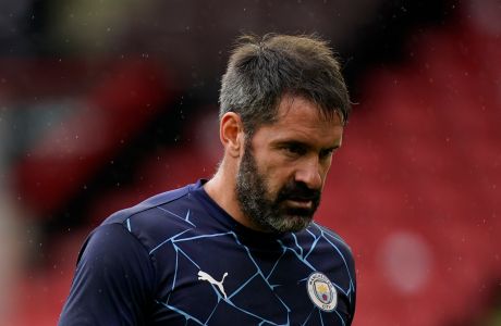 Manchester City goalkeeper Scott Carson walks off the pitch after suffering an injury in the warm up before the English Premier League soccer match between Sheffield United and Manchester City at Bramall Lane stadium in Sheffield, England, Saturday, Oct. 31, 2020. (Tim Keeton/Pool via AP)