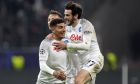 Napoli's Giovanni Di Lorenzo, left, celebrates with Napoli's Khvicha Kvaratskhelia after scoring his side's second goal during the Champions League round of 16 second leg soccer match between Eintracht Frankfurt and Napoli, at the Deutsche Bank Arena in Frankfurt, Germany, Tuesday, Feb. 21, 2023. (AP Photo/Michael Probst)