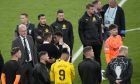 Real Madrid's Jude Bellingham, center, right, speaks with a Borussia Dortmund official at the end of the Champions League final soccer match between Borussia Dortmund and Real Madrid at Wembley stadium in London, Saturday, June 1, 2024. Real Madrid won 2-0. (AP Photo/Alastair Grant)