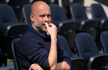 Manchester City's head coach Pep Guardiola waits for the start of the English Premier League soccer match between Fulham and Manchester City at the Craven Cottage Stadium in London, Saturday, May 11, 2024. (AP Photo/Kirsty Wigglesworth)