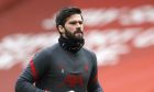 FILE - In this Sunday, March 7, 2021 file photo, Liverpool's goalkeeper Alisson warms up prior to their English Premier League soccer match against Fulham at Anfield stadium in Liverpool, England. Liverpool goalkeeper Alisson Becker signed a long-term contract extension on Wednesday, Aug. 4 the club said. The 28-year-old Brazil keeper's deal follows midfielder Fabinho and right back Trent Alexander-Arnold also extending at Liverpool. (Phil Noble/Pool via AP, file)