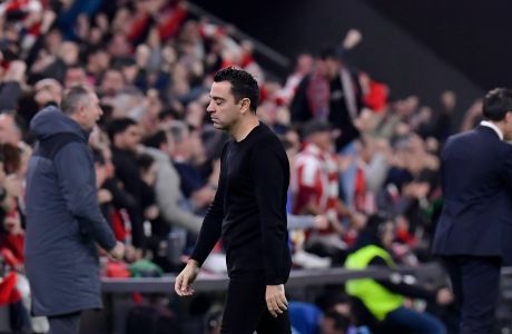 Barcelona's head coach Xavi Hernandez walks as Atlhletic Bilbao scores its second goal during the Copa del Rey quarterfinals soccer match between Athletic Bilbao and Barcelona at the San Mames stadium in Bilbao, Spain, on Wednesday, Jan. 24, 2024. (AP Photo/Alvaro Barrientos)