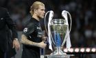 Liverpool goalkeeper Loris Karius walks past the trophy after the Champions League Final soccer match between Real Madrid and Liverpool at the Olimpiyskiy Stadium in Kiev, Ukraine, Saturday, May 26, 2018. Real Madrid won 3-1. (AP Photo/Pavel Golovkin)