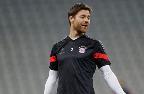 Bayerns Xabi Alonso from Spain smiles during a training session prior to the Champions League Group E soccer match between FC Bayern Munich and AS Roma at Allianz Arena in Munich, southern Germany, Tuesday Nov. 4, 2014. Bayern Munich will face Roma on Wednesday. (AP Photo/Matthias Schrader)