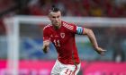 FILE - Wales' Gareth Bale runs during the World Cup group B soccer match between England and Wales, at the Ahmad Bin Ali Stadium in Al Rayyan , Qatar, Tuesday, Nov. 29, 2022.  The post-Gareth Bale era looked particularly daunting for Wales. A principality with a population of 3 million needed to replace its best ever player, a Real Madrid great, once the most expensive signing in soccer history. But the Welsh maybe neednt have worried because they are on the brink of qualifying for another major tournament. (AP Photo/Frank Augstein, File)