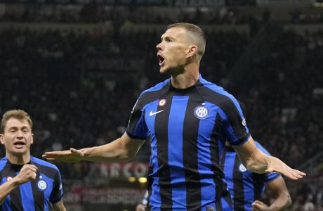 Inter Milan's Edin Dzeko, right, celebrates after scoring his side's opening goal during the Champions League semifinal first leg soccer match between AC Milan and Inter Milan at the San Siro stadium in Milan, Italy, Wednesday, May 10, 2023. (AP Photo/Antonio Calanni)