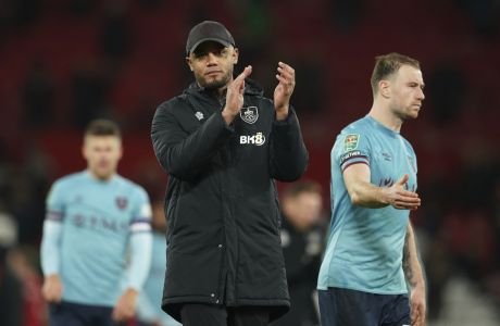 FILE - Burnley's manager Vincent Kompany applauds his teams fans after the end of the English League Cup 4th round soccer match against Manchester United, at Old Trafford in Manchester, England, Dec. 21, 2022. On Saturday, March 18, 2023 City fans can catch a view of the real-life Kompany when he returns to the Etihad. He is back as manager of second-division Burnley and will attempt to eliminate City from the FA Cup. (AP Photo/Dave Thompson, File)