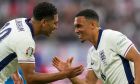 England's Jude Bellingham, left, celebrates with England's Trent Alexander-Arnold after scoring the opening goal during a Group C match between Serbia and England at the Euro 2024 soccer tournament in Gelsenkirchen, Germany, Sunday, June 16, 2024. (AP Photo/Martin Meissner)