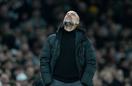 Manchester City's head coach Pep Guardiola reacts during the English FA Cup fourth round soccer match between Tottenham Hotspur and Manchester City in London, Friday, Jan. 26, 2024. (AP Photo/Dave Shopland)