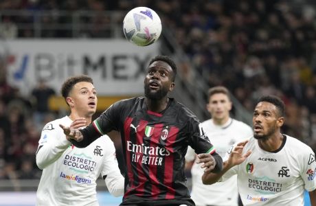 AC Milan's Divock Origi, center, challenges for the ball with Spezia's Ethan Ampadu, left, and Spezia's Kelvin Amian during the Serie A soccer match between AC Milan and Spezia at the San Siro stadium, in Milan, Italy, Saturday, Nov. 5, 2022. (AP Photo/Antonio Calanni)