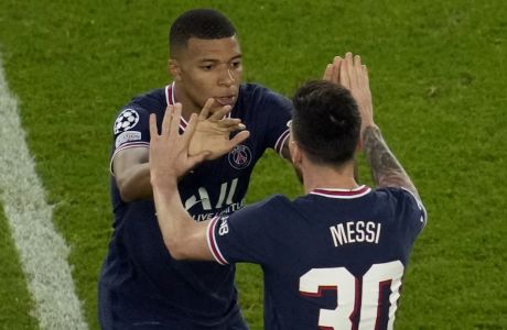 PSG's Lionel Messi, right, celebrates with his teammate Kylian Mbappe after scoring his side's third goal during his Champions League soccer match between Paris Saint Germain and RB Leipzig at the Parc des Princes stadium in Paris, Tuesday, Oct. 19, 2021. (AP Photo/Christophe Ena)