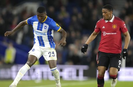 Brighton's Moises Caicedo, left, challenges for the ball with Manchester United's Anthony Martial during the English Premier League soccer match between Brighton and Hove Albion and Manchester United at the AMEX stadium in Brighton, England, Thursday, May 4, 2023. (AP Photo/Kirsty Wigglesworth)