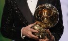 PSG player Lionel Messi holds the 2021 Ballon d'Or trophy during the 65th Ballon d'Or ceremony at Theatre du Chatelet, in Paris, Monday, Nov. 29, 2021. Messi won the Ballon d'Or for seventh time. (AP Photo/Christophe Ena)