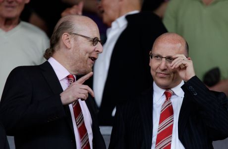 FILE - This April 9, 2011 file photo shows Manchester United directors Avram, left, and Joel Glazer before Manchester United's English Premier League soccer match against Fulham at Old Trafford Stadium in Manchester, England. Manchester United's American owners plan to dilute their stake in the Premier League champions with an initial public offering in Singapore, people familiar with the plans said Tuesday, Aug. 16, 2011. (AP Photo/Jon Super, File)   NO INTERNET/MOBILE USAGE WITHOUT FOOTBALL ASSOCIATION PREMIER LEAGUE(FAPL)LICENCE. EMAIL info@football-dataco.com FOR DETAILS.