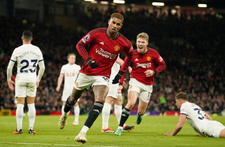 Manchester United's Marcus Rashford celebrates after scoring his side's second goal during the English Premier League soccer match between Manchester United and Tottenham Hotspur at the Old Trafford stadium in Manchester, England, Sunday, Jan.14, 2024. (AP Photo/Dave Thompson)