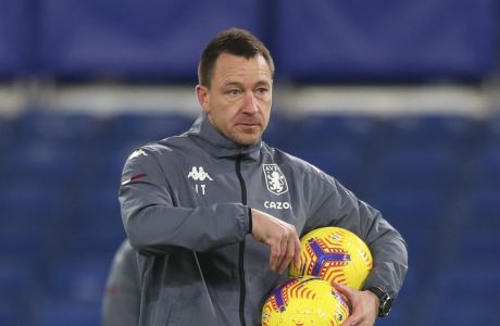 Aston Villa assistant head coach John Terry fetches balls during a warmup prior to the English Premier League soccer match between Chelsea and Aston Villa in London, England, Monday, Dec. 28, 2020. (Catherine Ivill/Pool via AP)