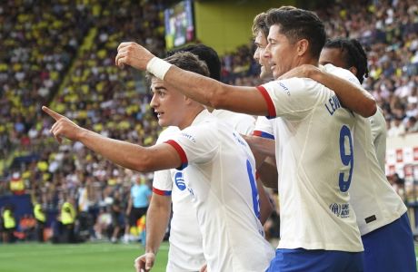 Barcelona's Gavi, left, celebrates with team mates after scoring the opening goal during a Spanish La Liga soccer match between Villarreal and Barcelona at the Ceramica stadium in Villarreal, Spain, Sunday, Aug. 27, 2023. (AP Photo/Alberto Saiz)