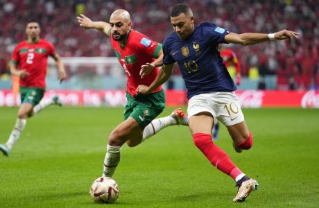 Morocco's Sofyan Amrabat, left, and France's Kylian Mbappe vie for the ball during the World Cup semifinal soccer match between France and Morocco at the Al Bayt Stadium in Al Khor, Qatar, Wednesday, Dec. 14, 2022. (AP Photo/Manu Fernandez)