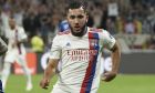 Lyon's Rayan Cherki, right, and Strasbourg's Jean-Ricner Bellegarde challenge for the ball during the French League One soccer match between Strasbourg RCSA and Olympique Lyonnais at the Groupama stadium in Lyon, France, Sunday, Sept. 12, 2021. (AP Photo/Laurent Cipriani)