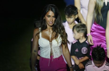 Antonela Roccuzzo, left, wife of Lionel Messi, walks with the couples children during an event to present Messi to fans one day after Inter Miami MLS soccer team finalized his signing through the 2025 season, Sunday, July 16, 2023, in Fort Lauderdale, Fla. (AP Photo/Rebecca Blackwell)