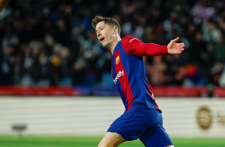 Barcelona's Robert Lewandowski celebrates scoring his side's 2nd goal during the Spanish La Liga soccer match between Barcelona and Granada at the Olimpic Lluis Companys stadium in Barcelona, Spain, Sunday, Feb. 11, 2024. (AP Photo/Joan Monfort)