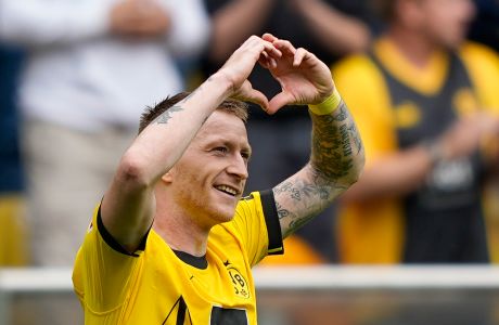 Dortmund's Marco Reus celebrates after he scored his side's fourth goal during the German Bundesliga soccer match between Borussia Dortmund and Augsburg, in Dortmund, Saturday, May 4, 2024. (AP Photo/Martin Meissner)