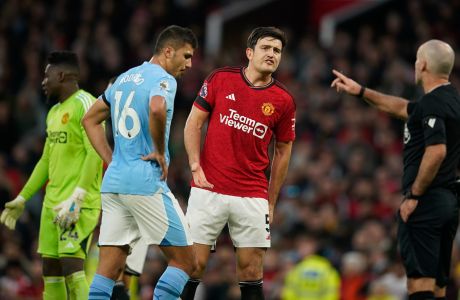 Manchester United's Harry Maguire, centre, is warned by the referee as penalty is awarded for Manchester City during the English Premier League soccer match between Manchester United and Manchester City at Old Trafford stadium in Manchester, England, Sunday, Oct. 29, 2023. (AP Photo/Dave Thompson)