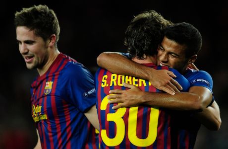 FC Barcelona's Sergi Roberto, center, is congratulated by his teammate Rafinha, right, after scores against Bate Borisov during a Champions League soccer match group H at the Nou Camp stadium in Barcelona, Spain, Tuesday, Dec 6, 2011. (AP Photo/Manu Fernandez)