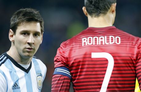 Lionel Messi of Argentina, left, stands next to Cristiano Ronaldo of Portugal before their International Friendly soccer match at Old Trafford Stadium, Manchester, England, Tuesday Nov. 18, 2014. (AP Photo/Jon Super)  