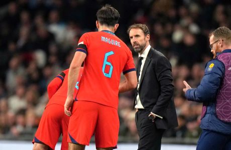 England's head coach Gareth Southgate talks with his player Harry Maguire during the UEFA Nations League soccer match between England and Germany at the Wembley Stadium in London, England, Monday, Sept. 26, 2022. (AP Photo/Alastair Grant)