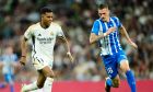 Real Madrid's Rodrygo, left, challenges for the ball with Alaves' Rafa Marin during the Spanish La Liga soccer match between Real Madrid and Deportivo Alaves at the Santiago Bernabeu stadium in Madrid, Spain, Tuesday, May 14, 2024. (AP Photo/Jose Breton)