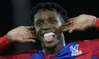 Crystal Palace's Wilfried Zaha celebrates after he scored his side's first goal during the English Premier League soccer match between Crystal Palace and Brighton, at Selhurst Park, London, Monday, Sept. 27, 2021. (AP Photo/Matt Dunham)