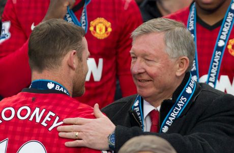 Manchester United's manager Sir Alex Ferguson, right, speaks to striker Wayne Rooney after his last home game in charge of the club, their English Premier League soccer match against Swansea City, at Old Trafford Stadium, Manchester, England, Sunday May 12, 2013. (AP Photo/Jon Super)  
