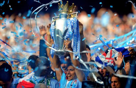 MANCHESTER, ENGLAND - MAY 13:  Scorer of the matchwinning goal Sergio Aguero of Manchester City celebrates with the trophy during the Barclays Premier League match between Manchester City and Queens Park Rangers at the Etihad Stadium on May 13, 2012 in Manchester, England.  (Photo by Shaun Botterill/Getty Images)