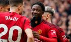 Manchester United's Kobbie Mainoo, centre, celebrates with teammates after scoring his side's second goal during the English Premier League soccer match between Manchester United and Liverpool at the Old Trafford stadium in Manchester, England, Sunday, April 7, 2024. (AP Photo/Dave Thompson)